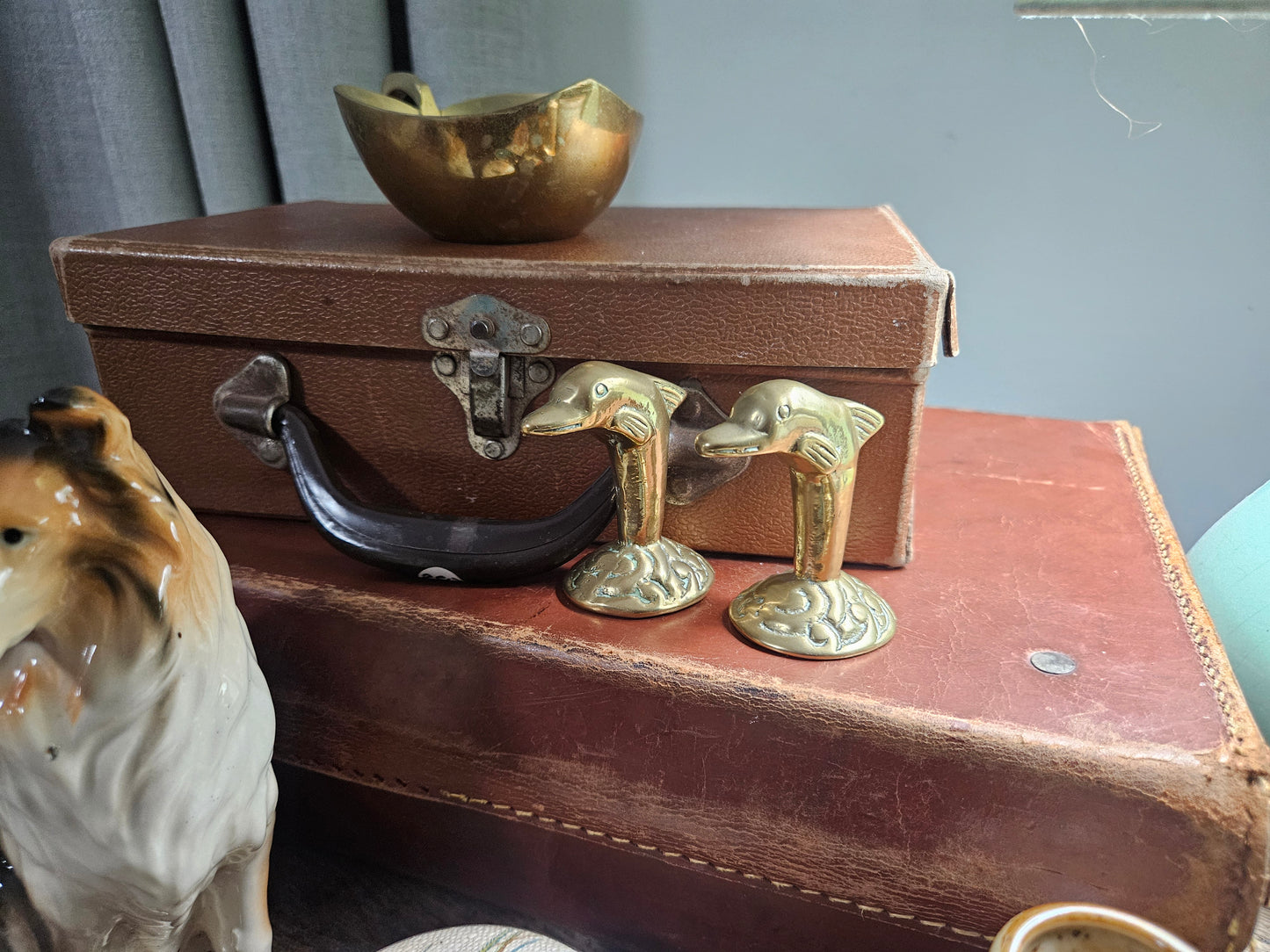 Pair of brass dolphin figurines