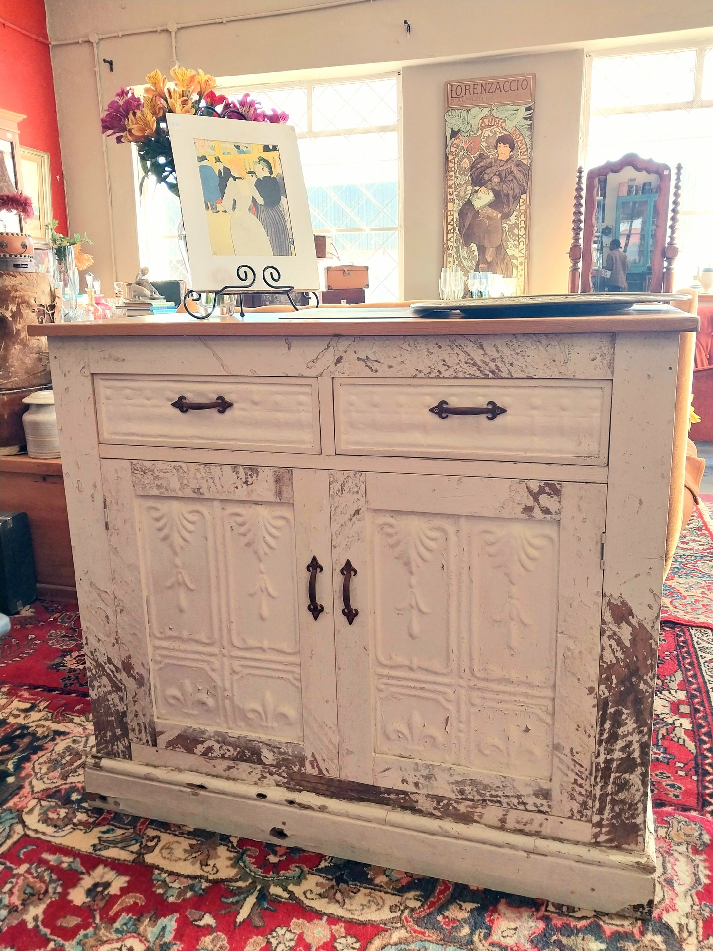 Distressed wooden cabinet with decorative elements in a room setting