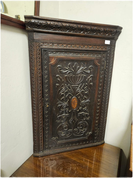 Ornately carved corner cabinet