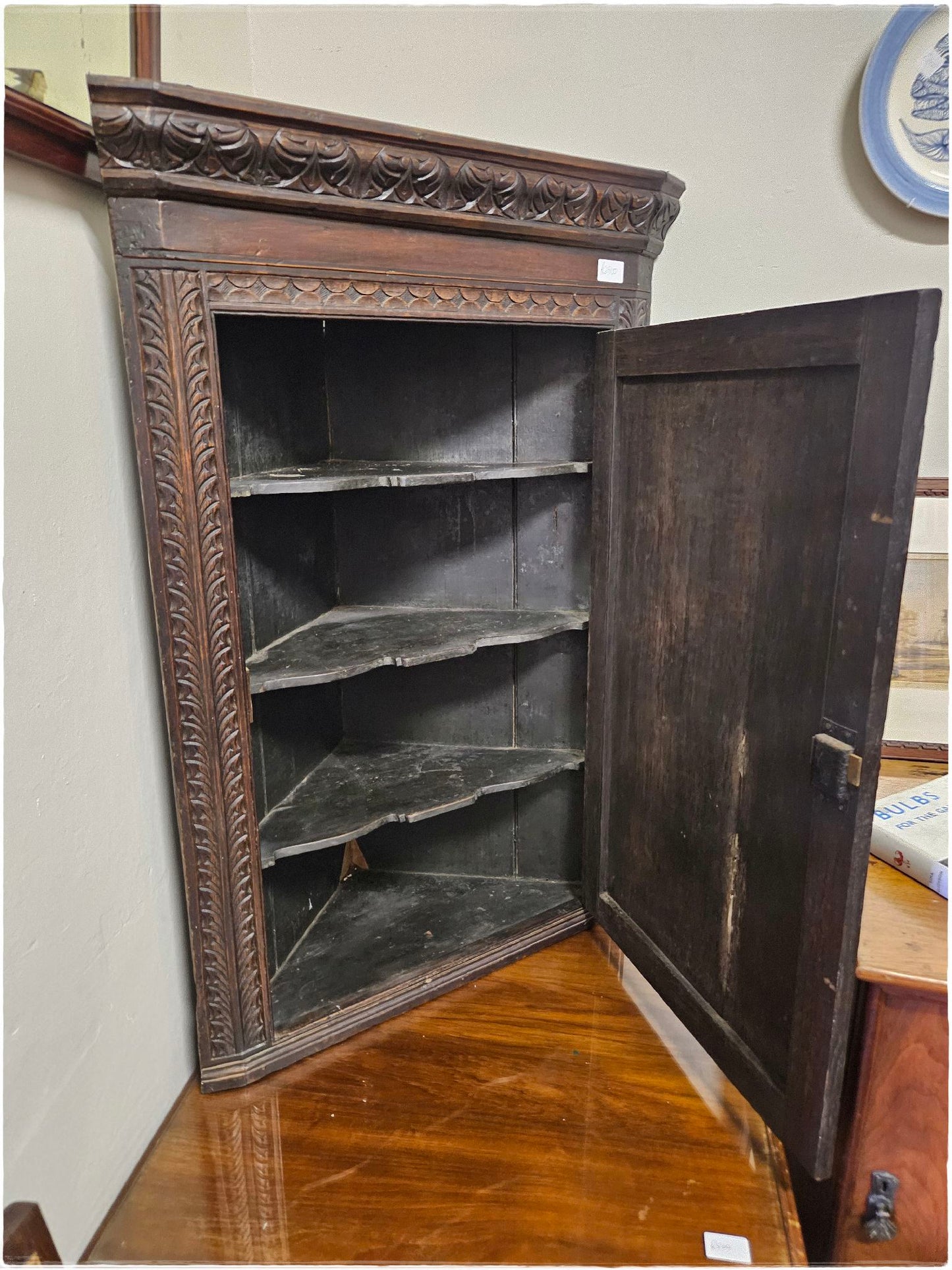 Ornately carved corner cabinet