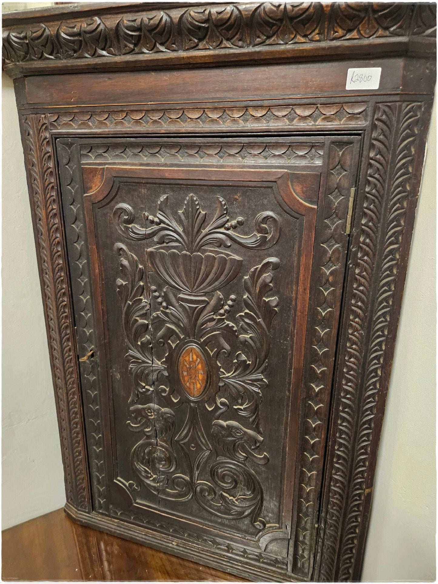 Ornately carved corner cabinet