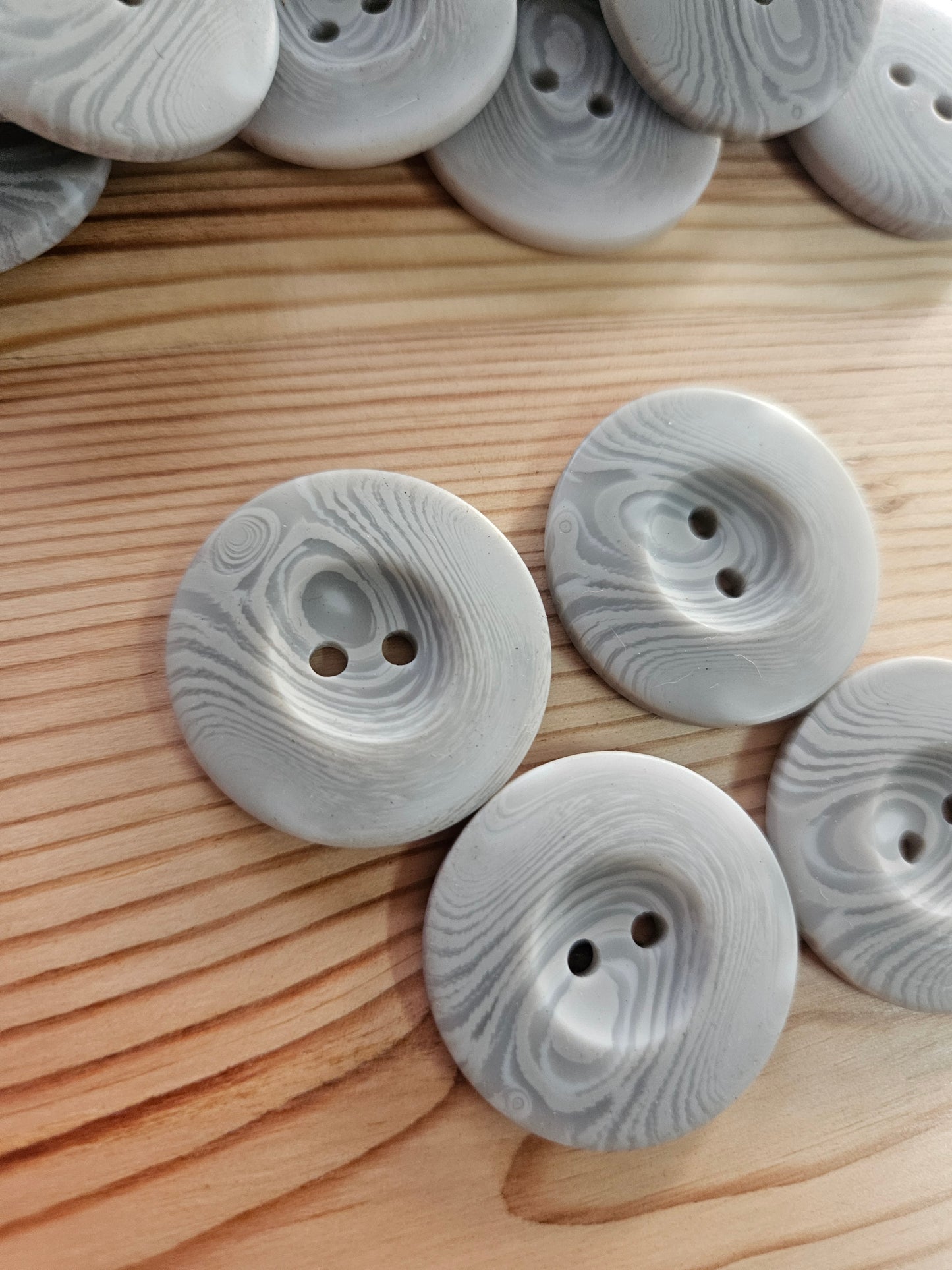 Large grey swirl buttons