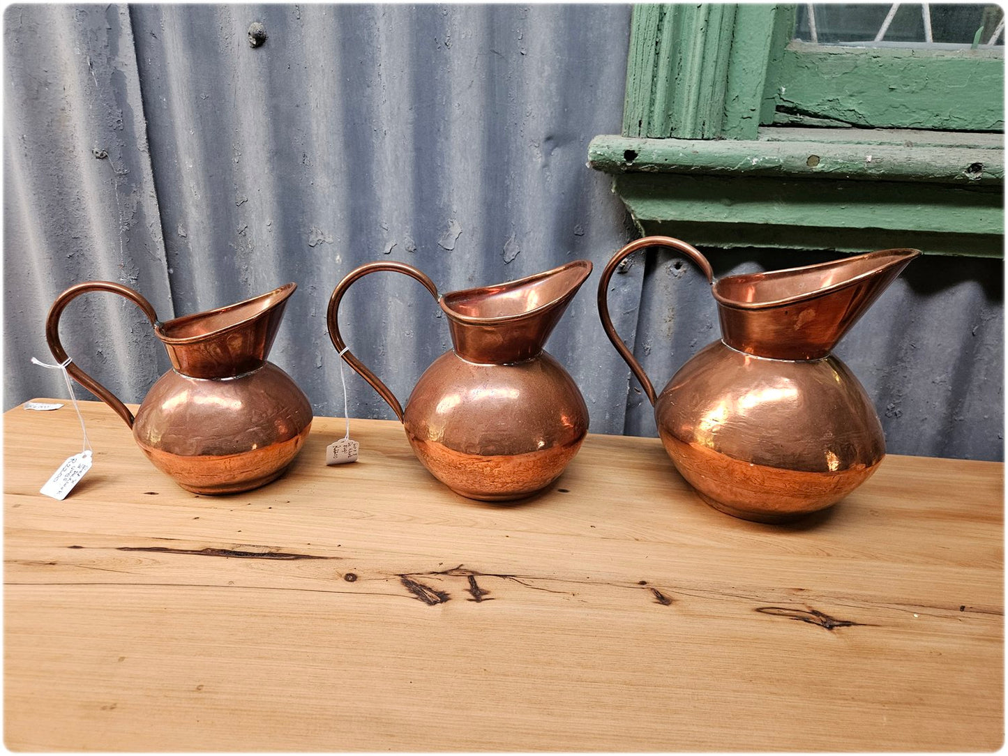 Graduated set of 3 De Klerk copper jugs