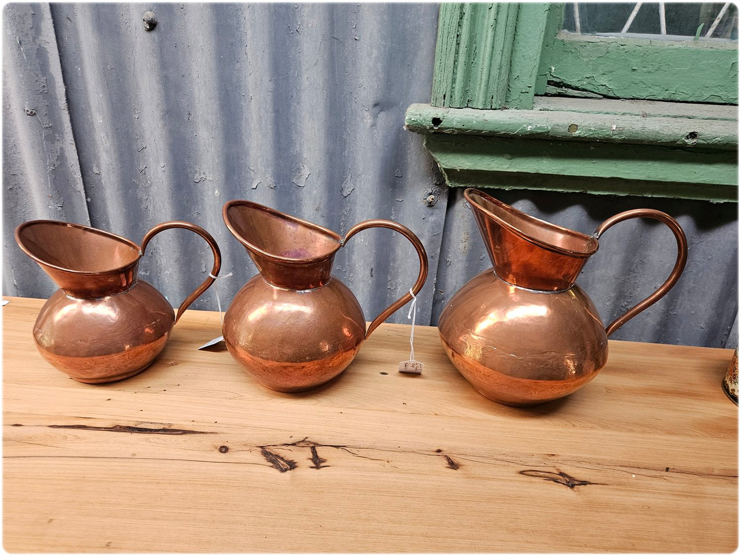 Graduated set of 3 De Klerk copper jugs