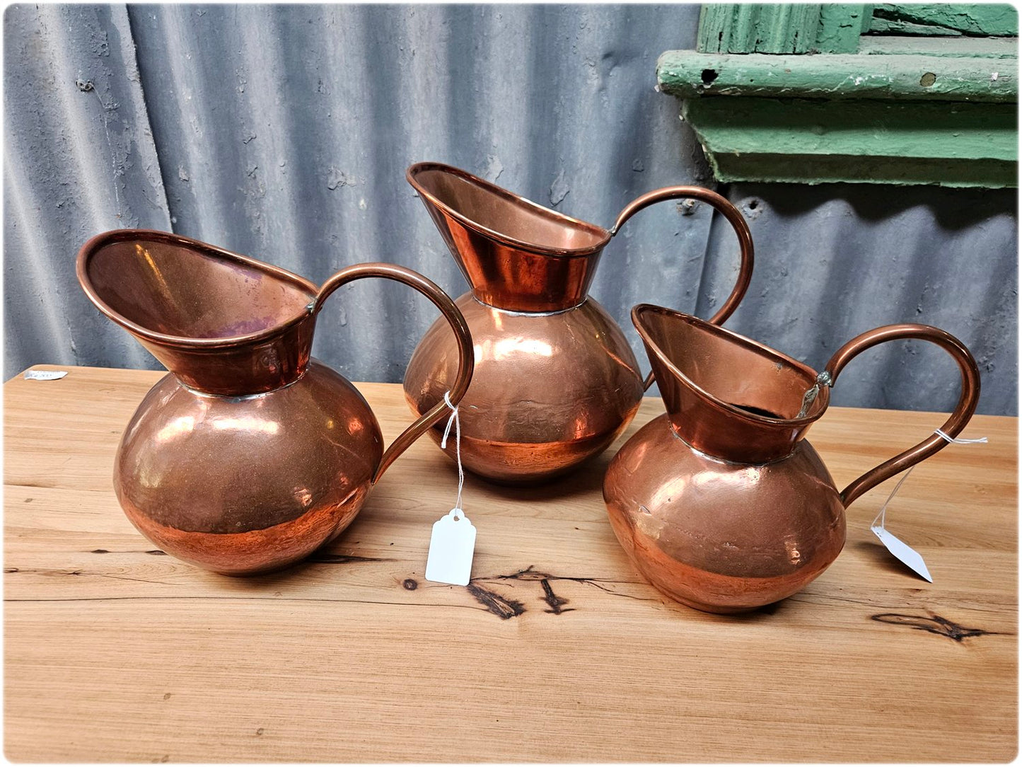 Graduated set of 3 De Klerk copper jugs