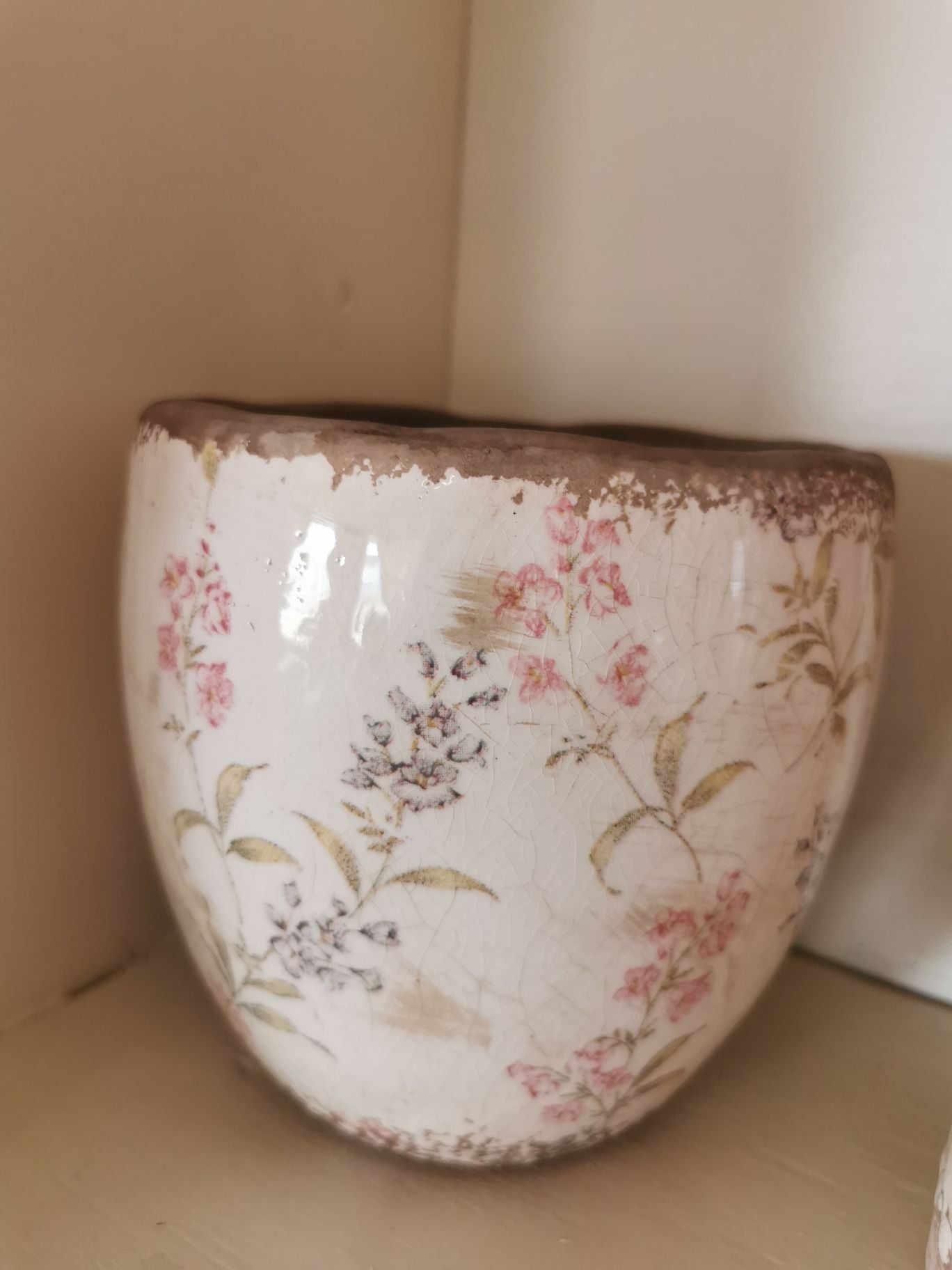 Plant pot with muted red and black flowers