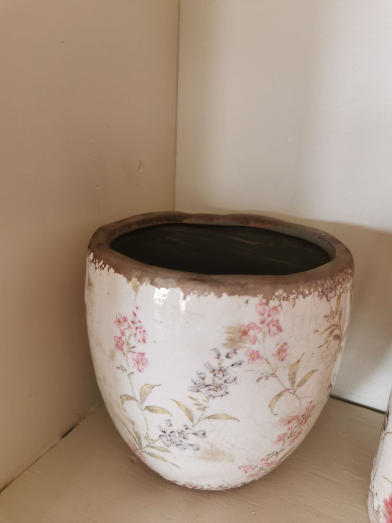 Plant pot with muted red and black flowers