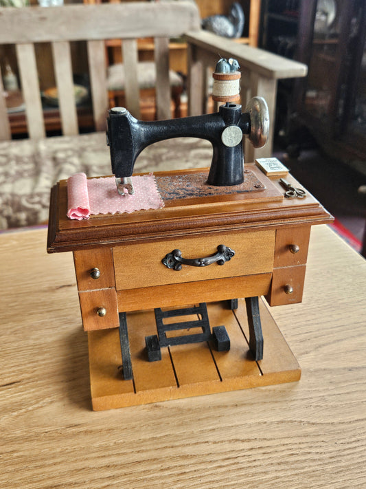 Miniature musical sewing machine